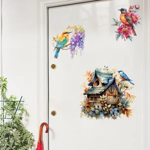 Detailed view of watercolor bird and birdhouse wall stickers applied to a white door