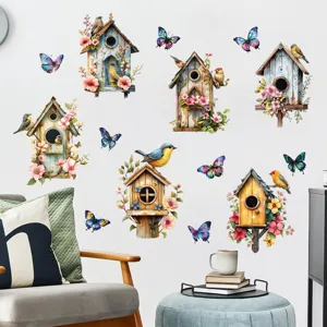 Detailed view of watercolor birdhouse and butterfly wall stickers in a cozy room