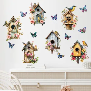 Close-up of birdhouse and butterfly wall decals applied to a clean white living room wall