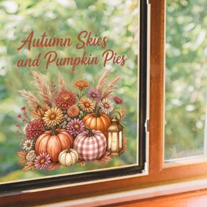 Primo piano di decorativo adesivo per finestre autunnale con zucche e fiori.