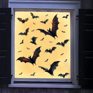 Detailed view of Halloween bat window decals on glass with orange background light