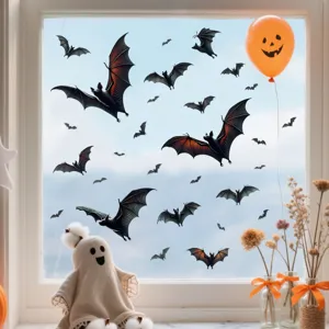 Close-up detail showing various 3D Halloween bat stickers applied to a clear window pane
