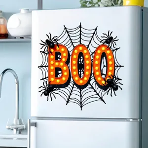 Detailed view of a Halloween BOO decal with spiderwebs and spiders on a white fridge