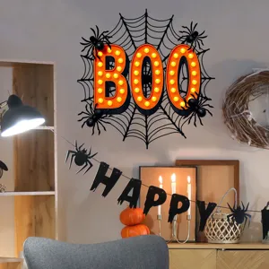 Detail view of festive BOO wall sticker and HAPPY banner in Halloween home decor