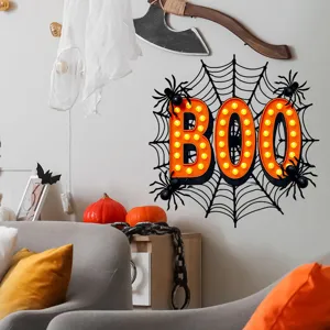 Halloween BOO wall decal with spiderweb and spiders displayed on a decorated room wall
