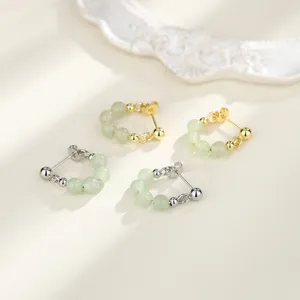 Close-up of New Chinese style pale green jade bead earrings in gold and silver finish