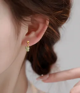 Detail view of elegant New Chinese style Hetian jade bead earrings worn by a female model