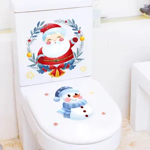 Detailed view of Christmas Santa and snowman stickers on a white toilet lid and tank