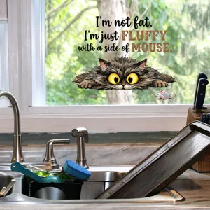 Close-up detail of fluffy cat window sticker with humorous English quote in kitchen