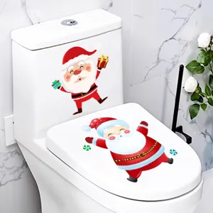 Detail view showing festive Santa Claus stickers applied on a white bathroom toilet lid.