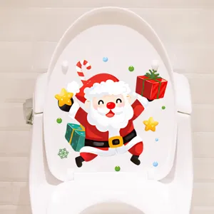 Detail view of a cartoon Santa Claus sticker applied on a white toilet lid.