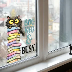 Detailed macro view of a cute cat on books window sticker with Booked & Busy text.