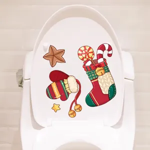 Detailed view of festive Christmas stocking and mitten stickers on a white toilet seat lid.