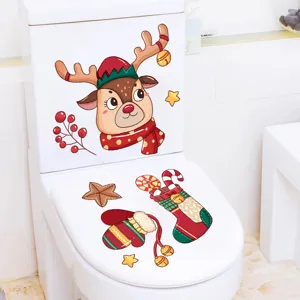 Detailed view of festive Christmas reindeer and stocking stickers on a white toilet