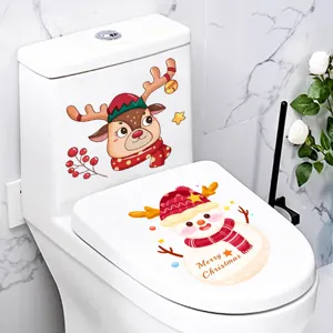 Close-up of festive reindeer and snowman Christmas stickers on a white toilet lid