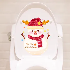 Detail view of a cute cartoon snowman Christmas sticker applied to a white toilet lid