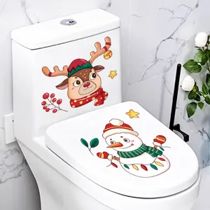 Detail of festive Christmas reindeer and snowman stickers applied to a white toilet lid