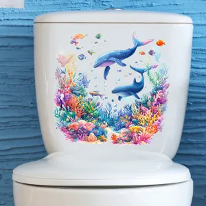 Close-up of a colorful underwater dolphin and whale wall sticker applied to a toilet tank