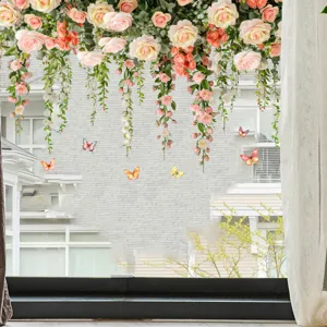 Floral window decals with hanging roses and colorful butterflies on a bright pane