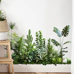 Tropical green plant wall sticker detail showing various leaves along a white baseboard.