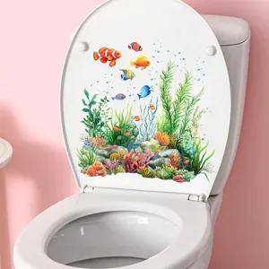 Colorful underwater world sticker with fish and coral reef on a white toilet lid cover.