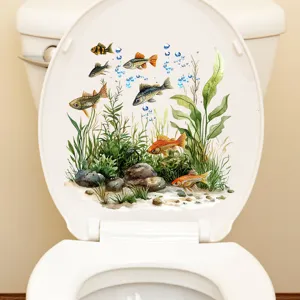 Detail view of a waterproof underwater fish and seaweed sticker on a white toilet lid.