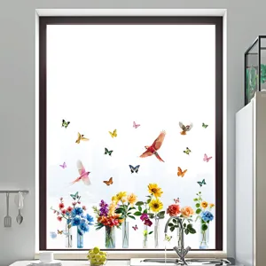 Detail view of colorful bird and flower static stickers applied to a kitchen window