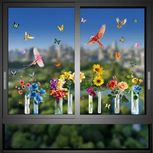 Detailed view of colorful bird and flower static cling window decals on a glass window