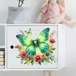 Detail view of a vibrant green butterfly wall decal applied to a white cabinet door.