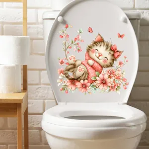 Cute cartoon cat and flowers sticker applied on a white toilet lid.