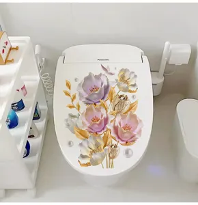 Beautiful 3D floral sticker with purple flowers and golden leaves on a white toilet lid