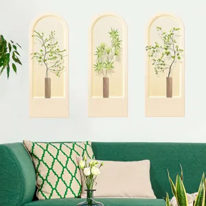 Lifestyle detail of three arched artificial plant wall stickers above a green sofa