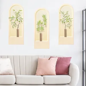 Modern arch-shaped botanical wall stickers featuring green plants above a living room sofa