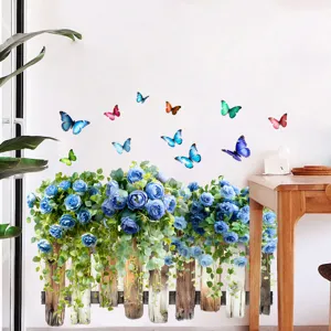 Detailed view of vibrant blue rose and colorful butterfly wall sticker on a white wall