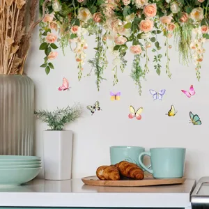 Detail view of floral rose vine and colorful butterfly wall decals in a kitchen setting.