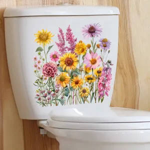 Detailweergave van kleurrijke zonnebloemstickers aangebracht op een wit toiletreservoir.