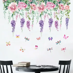 Scene showing floral wall stickers with butterflies and dragonflies over a table.