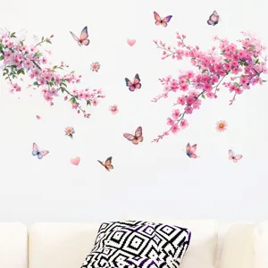 Detailed view of pink peach blossom and butterfly wall decals on a living room wall.