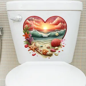 Heart-shaped beach sunset wall sticker with seashells applied to a white toilet tank