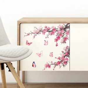 Elegant pink cherry blossom wall decals with butterflies applied to a cabinet door.