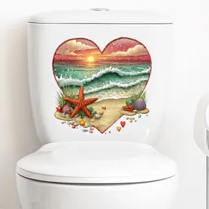 Detail view of heart-shaped beach sunset sticker applied on a white toilet tank.