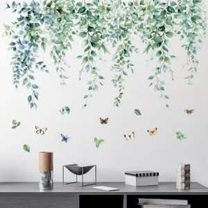 Lifestyle scene showing watercolor green leaf vines and butterfly wall stickers on a white wall.