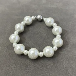 Detailed view of elegant pearl necklace with large and small beads and magnetic clasp