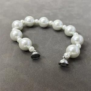 Close-up of elegant pearl necklace with convenient magnetic clasp closure.