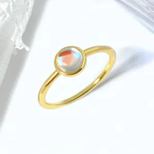 Detailed macro view of an elegant gold ring with round iridescent moonstone