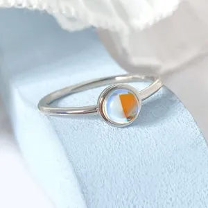 Macro detail of artificial moonstone ring with beautiful iridescent reflections