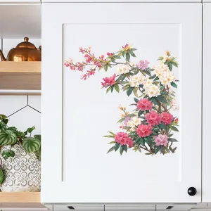 Floral wall sticker with pink blossoms applied to a modern white kitchen cabinet.