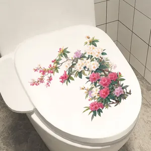 Vibrant pink and white plum blossom floral sticker applied on a clean white toilet lid