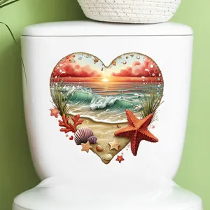 Heart-shaped beach sunset sticker on a toilet tank, featuring starfish and seashells.