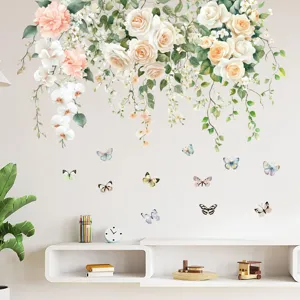 Detailed view of pastel rose vines and butterfly wall decals applied to a white living room wall